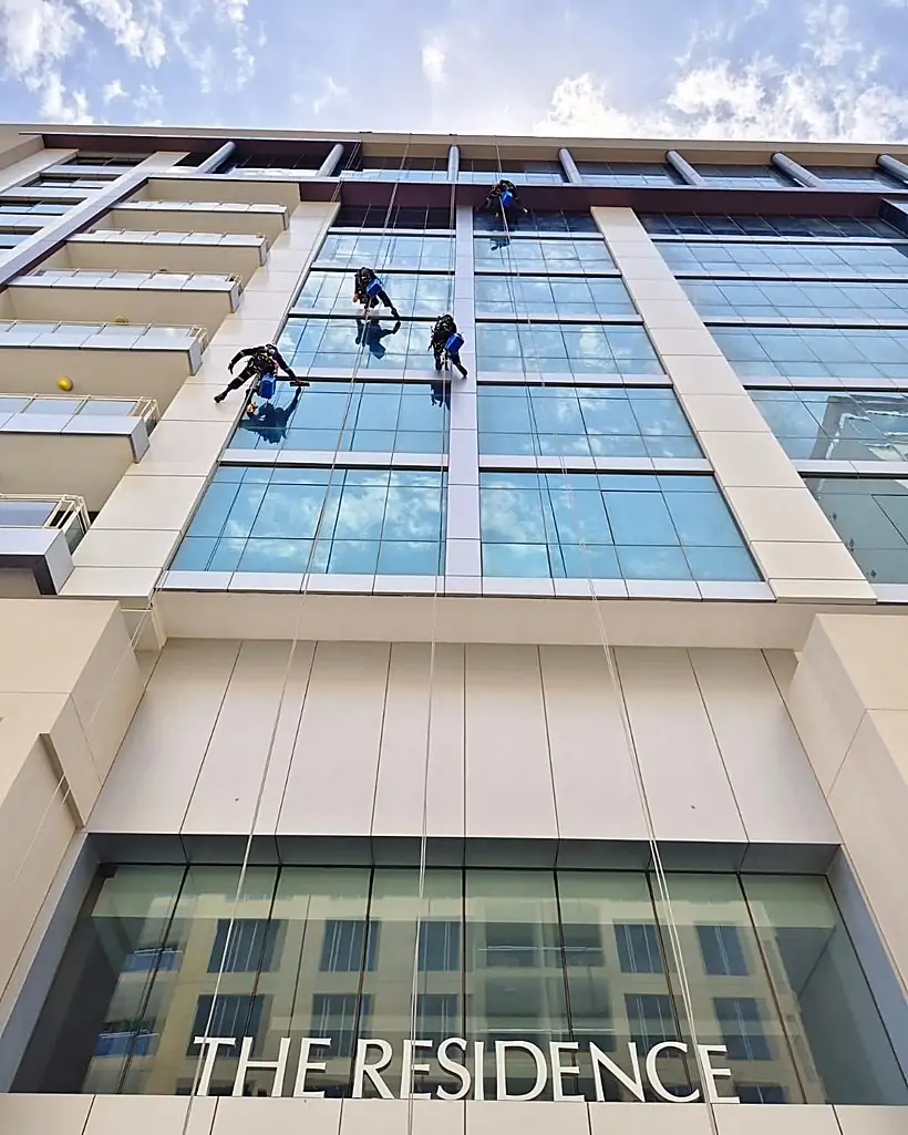 Rope access technicians abseiling The Residence tower, Amwaj Island